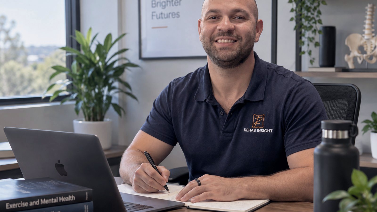 Exercise physiologist working at a desk preparing a client program
